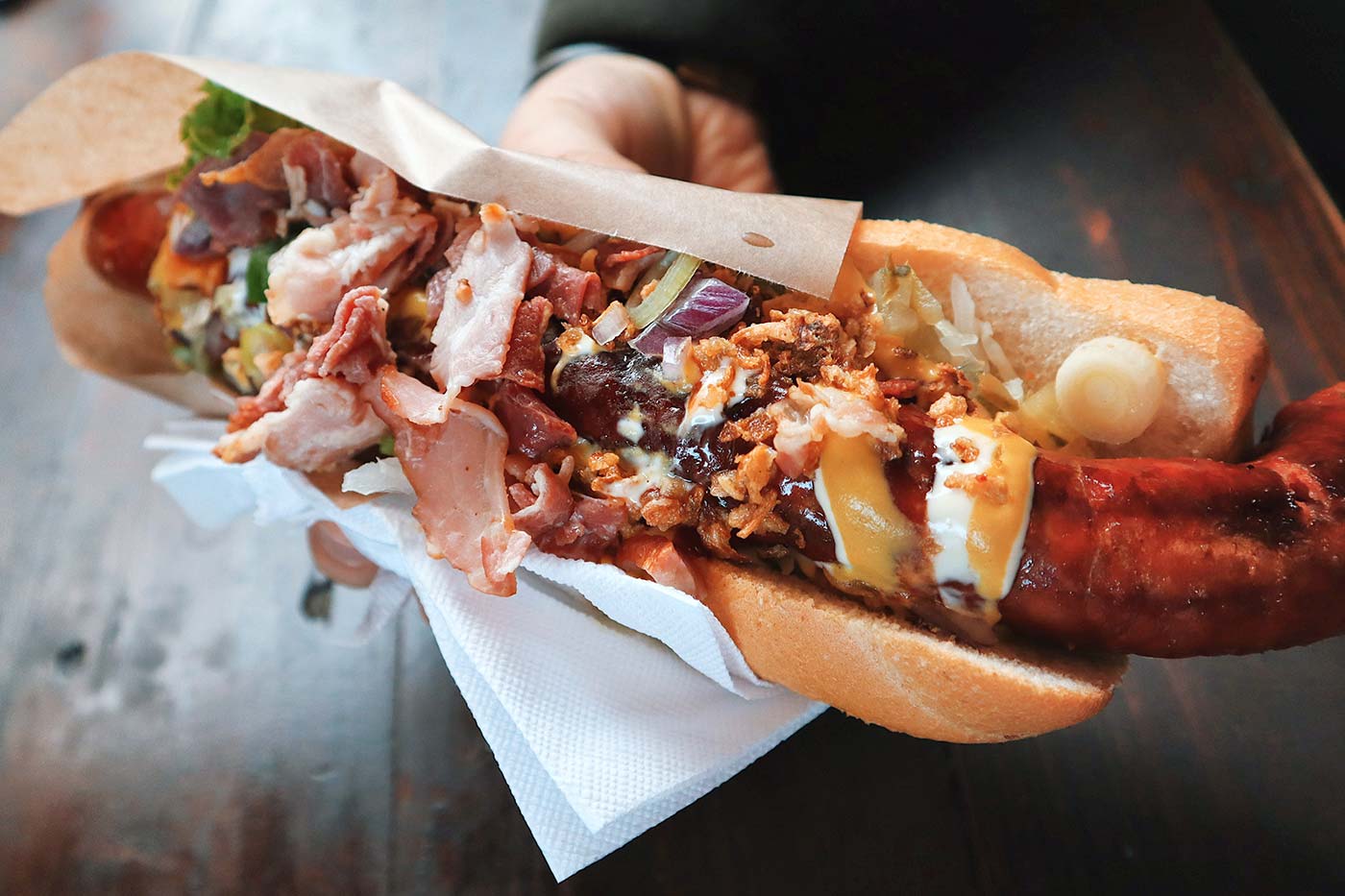 Hand Holding Loaded Hot Dog, by Ion Şipilov via Unsplash